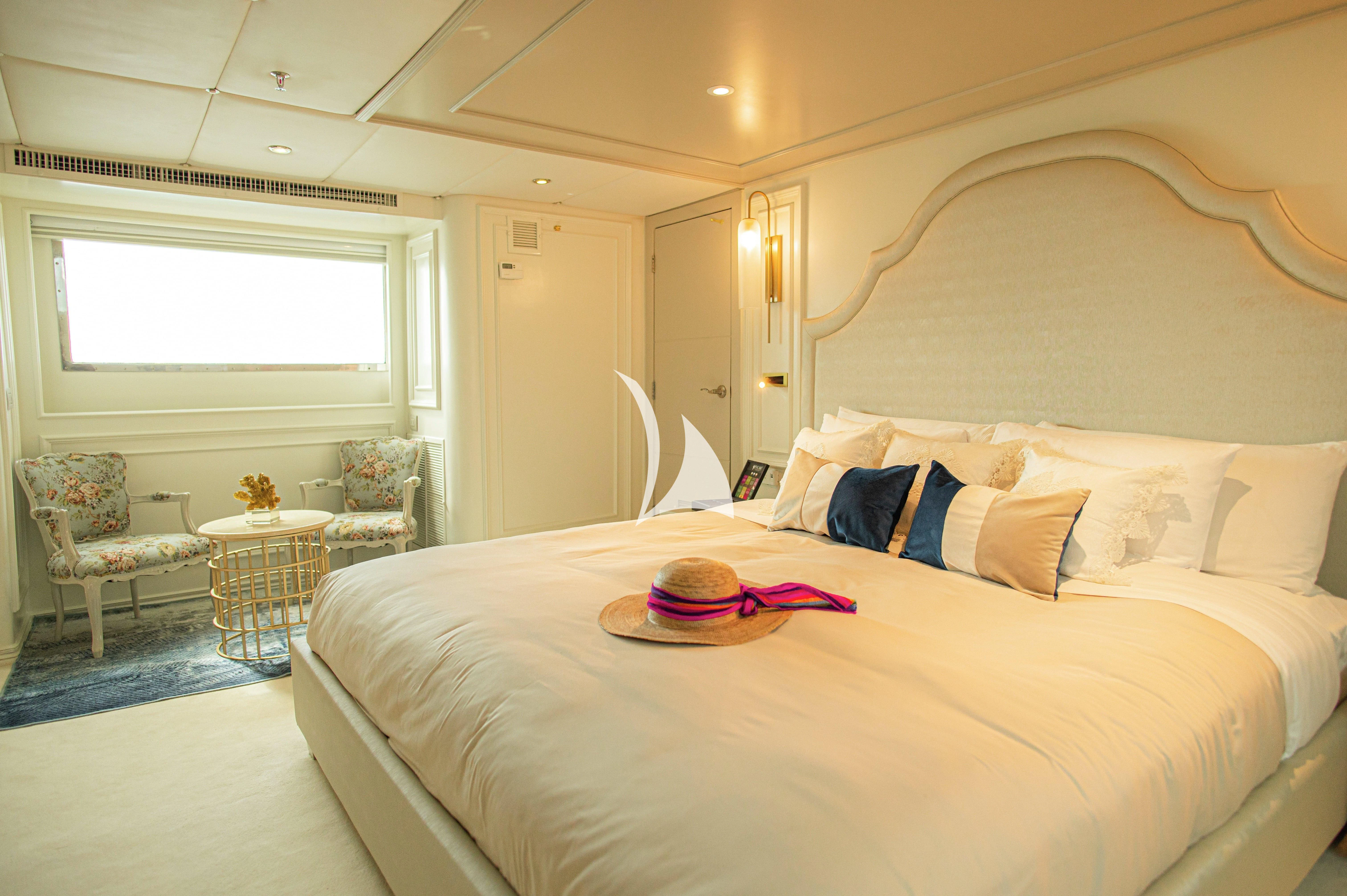 a bed with a white sheet and pillows aboard GALAPAGOS EXPLORER Yacht for Sale