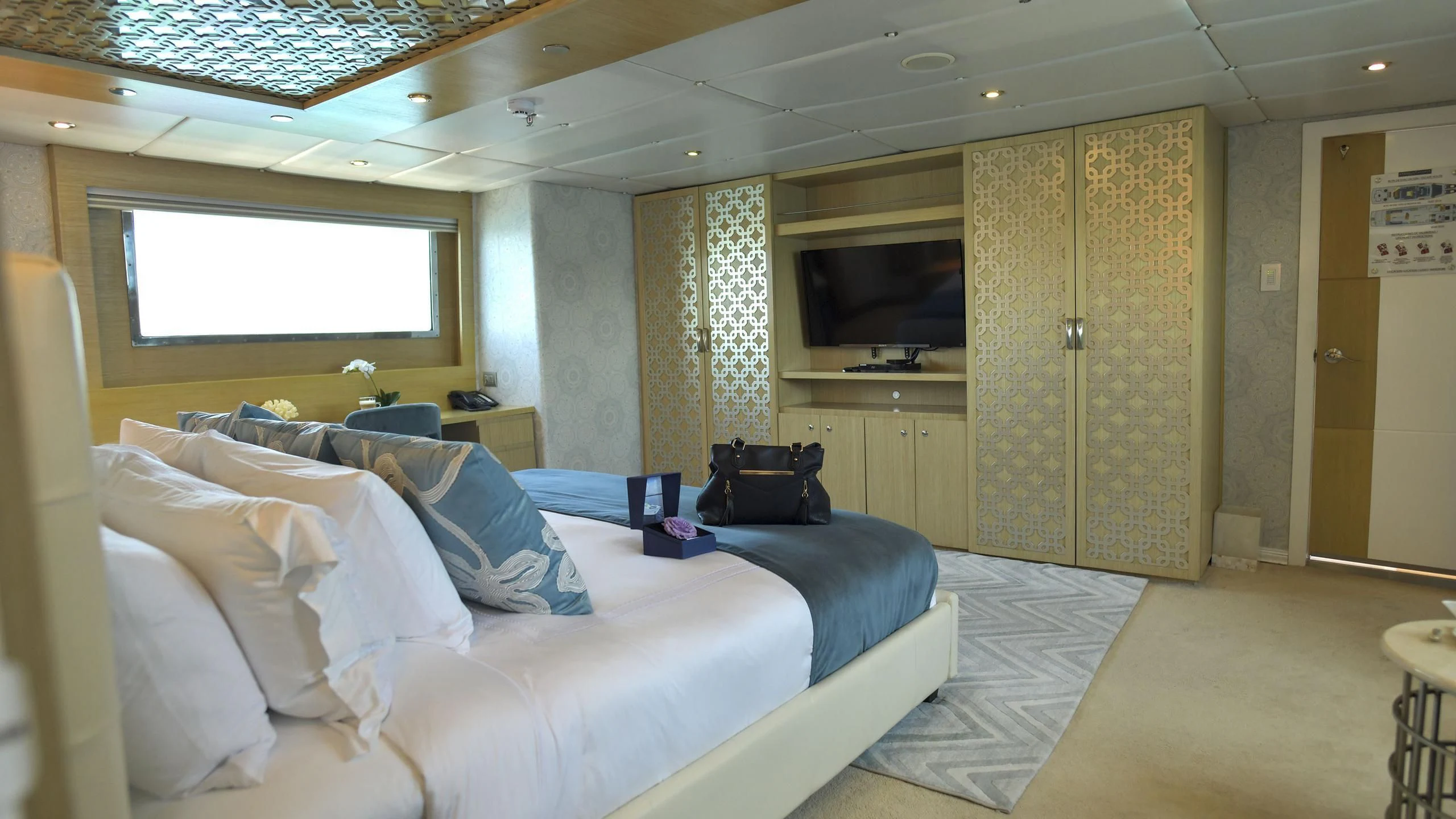 a room with beds and a television aboard GALAPAGOS EXPLORER Yacht for Sale