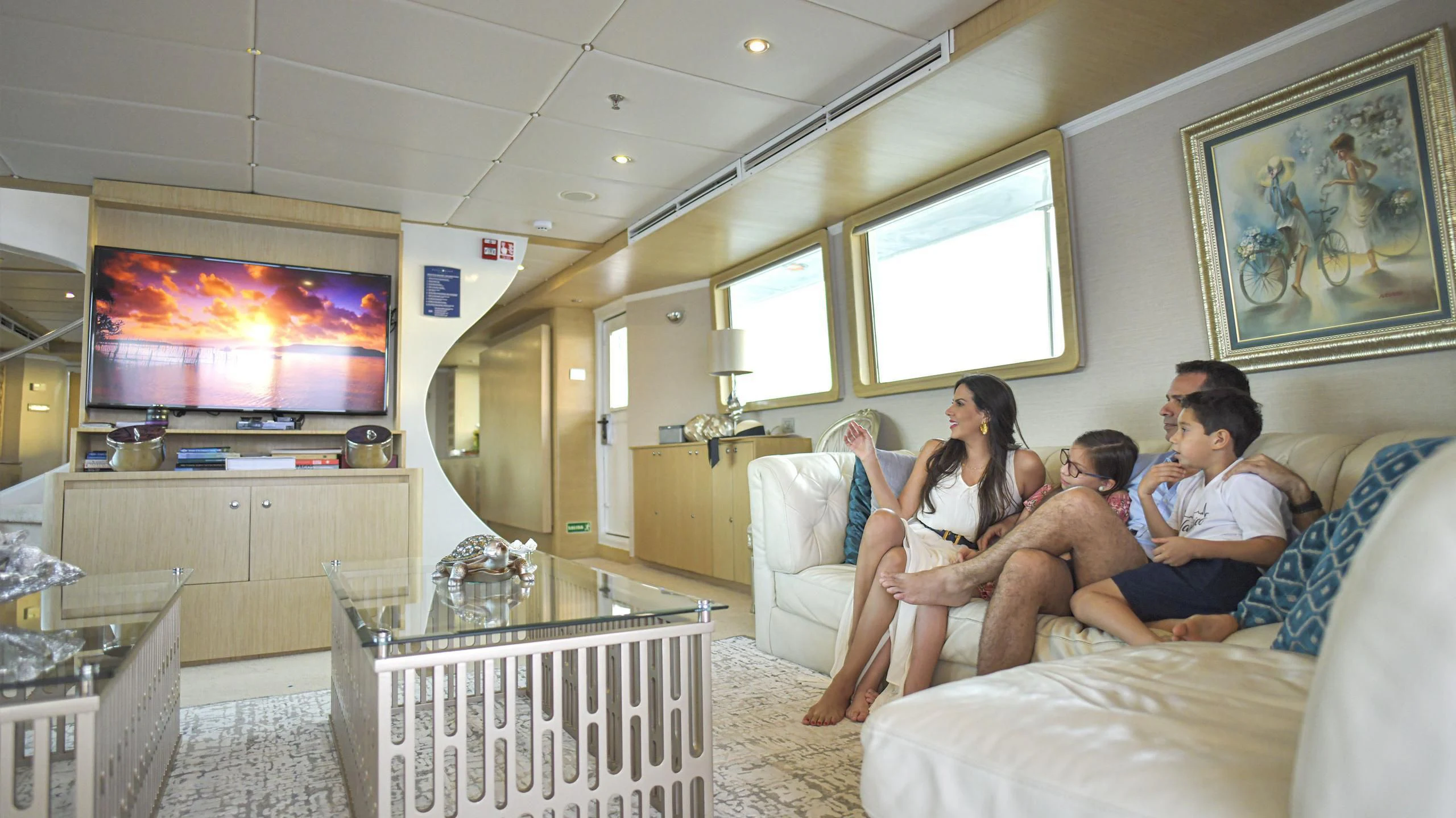 a group of people sitting on a couch watching television aboard GALAPAGOS EXPLORER Yacht for Sale