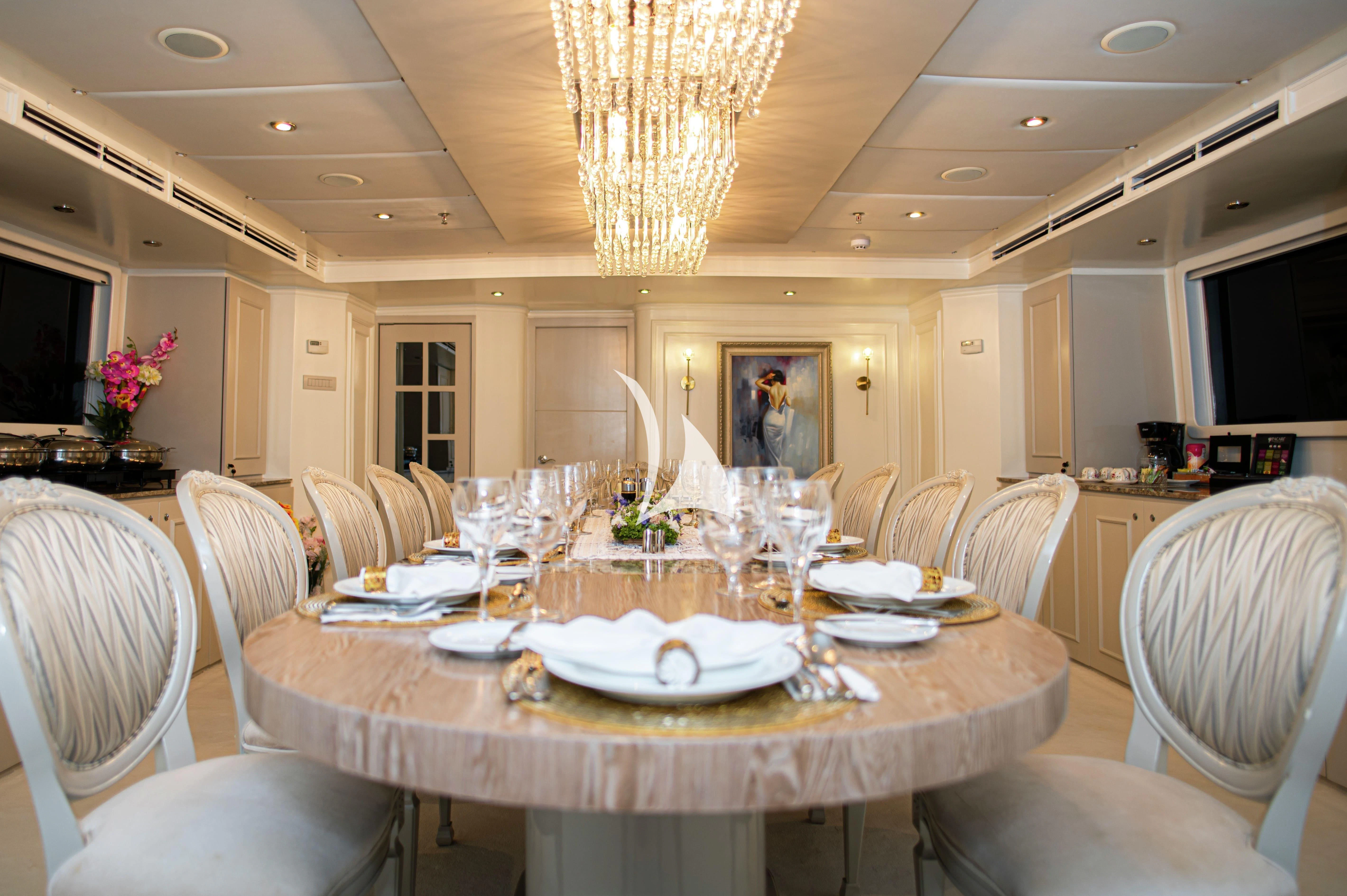 a dining room with white tables and chairs aboard GALAPAGOS EXPLORER Yacht for Sale