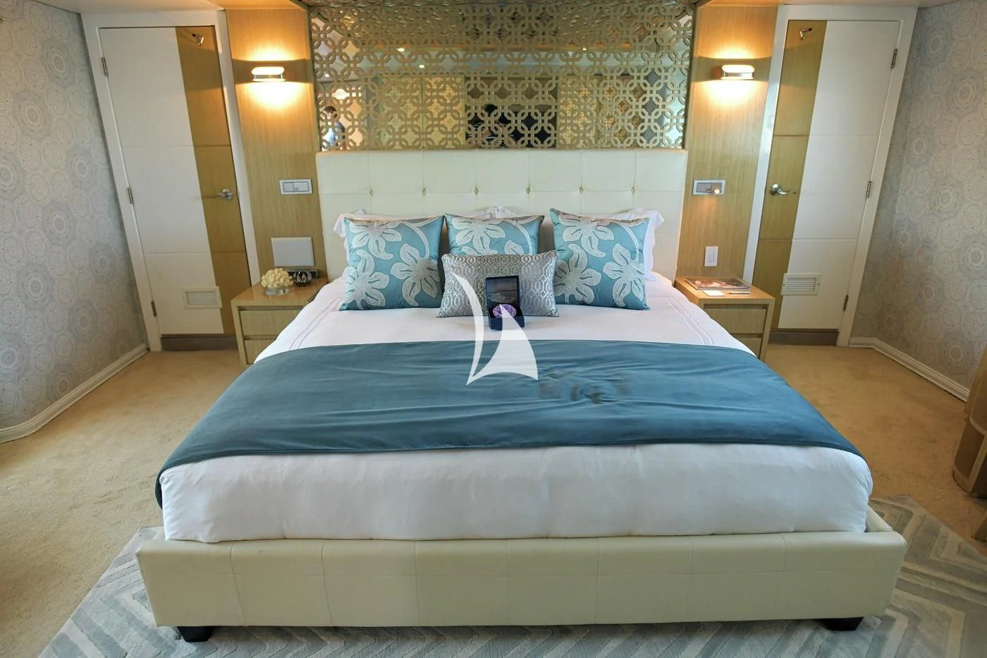 a bed with blue sheets aboard GALAPAGOS EXPLORER Yacht for Sale