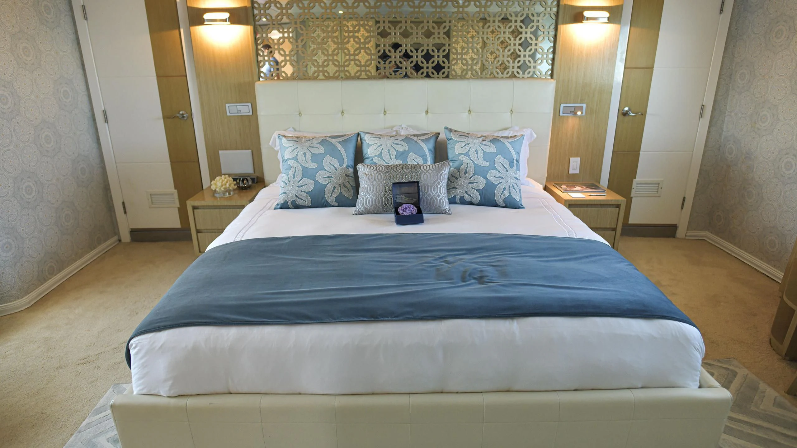 a bed with blue sheets aboard GALAPAGOS EXPLORER Yacht for Sale