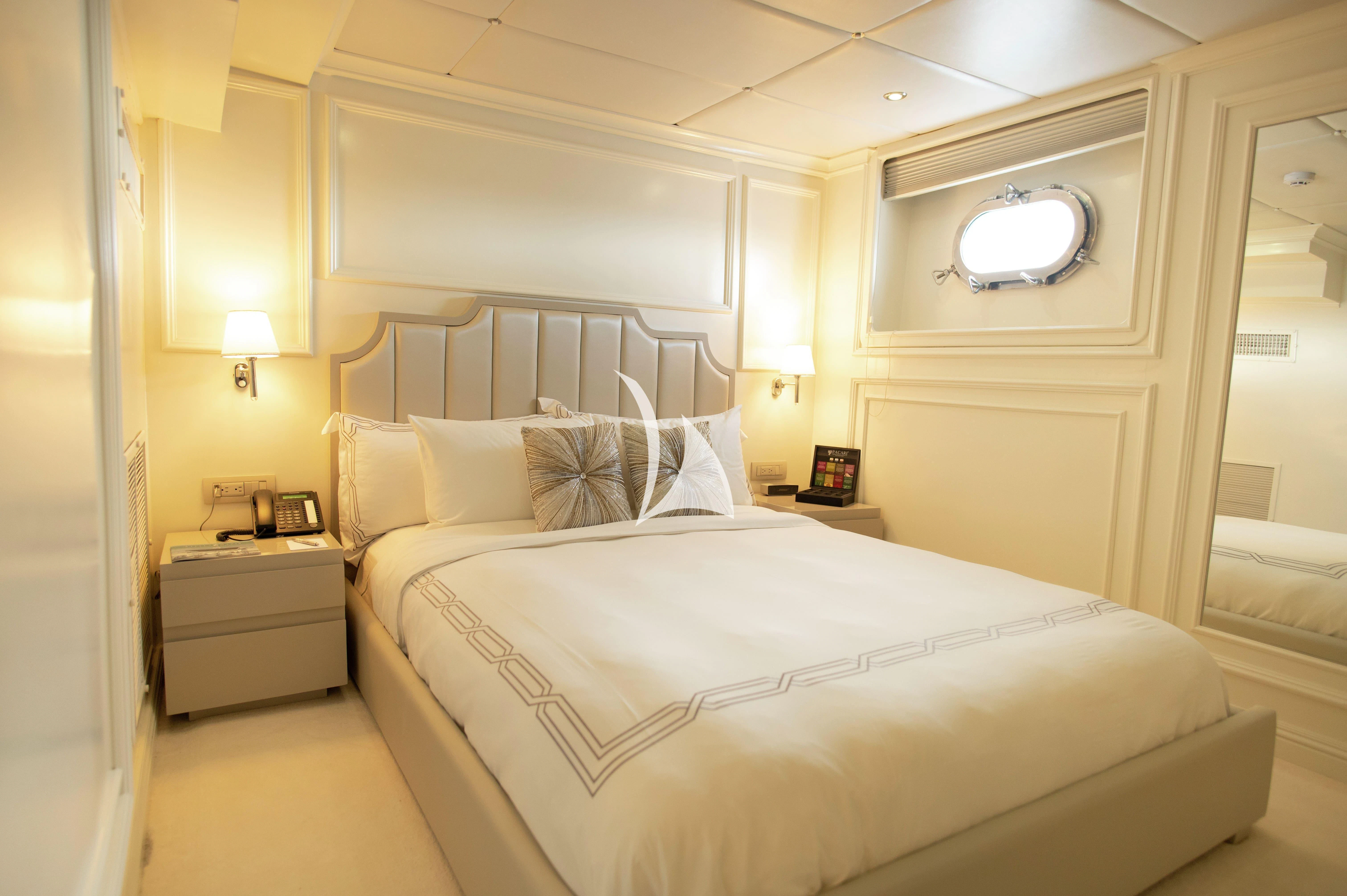 a bed with white sheets aboard GALAPAGOS EXPLORER Yacht for Sale