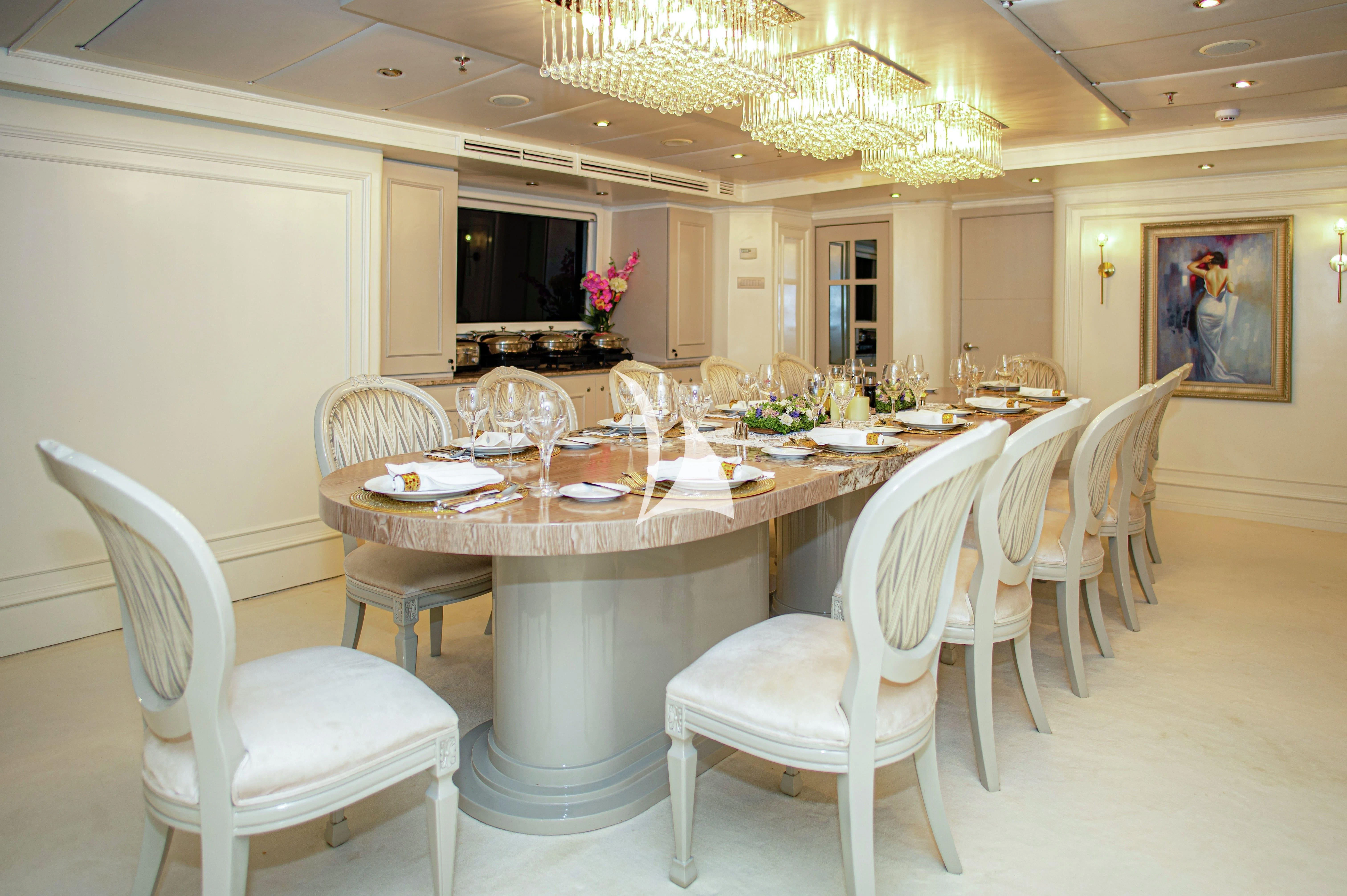 a dining table set for a meal aboard GALAPAGOS EXPLORER Yacht for Sale