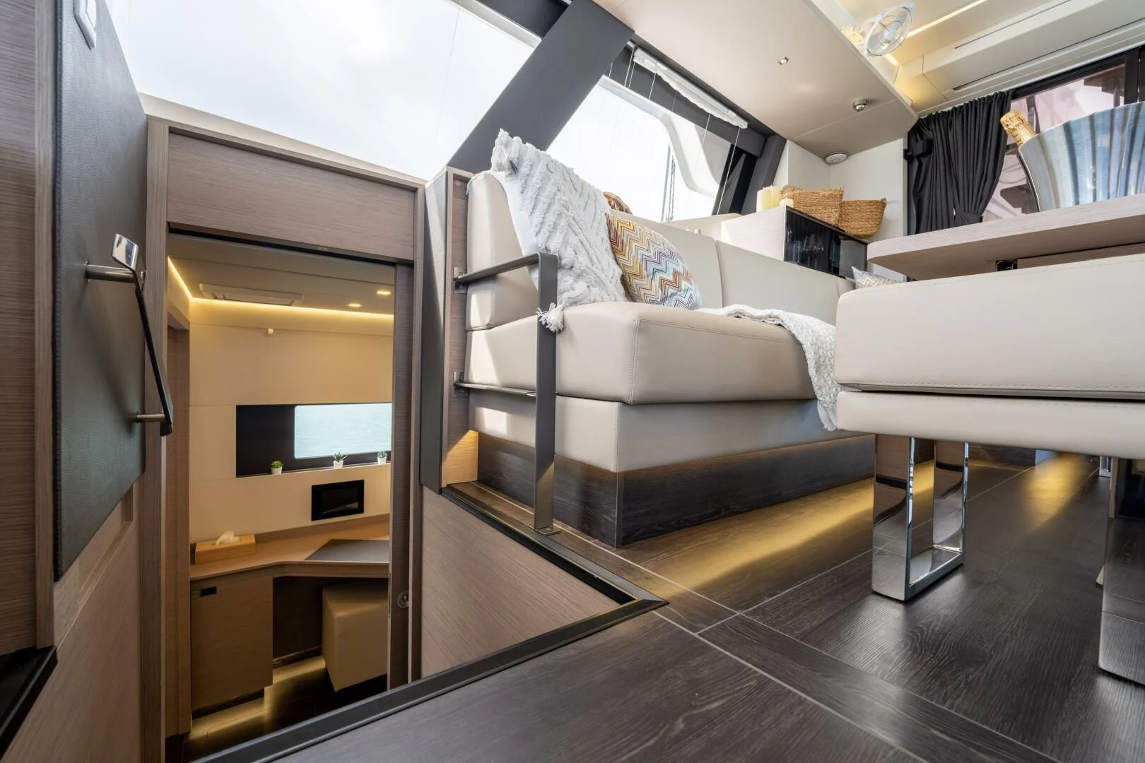 a room with a bed and desk aboard OCEANUS Yacht for Sale