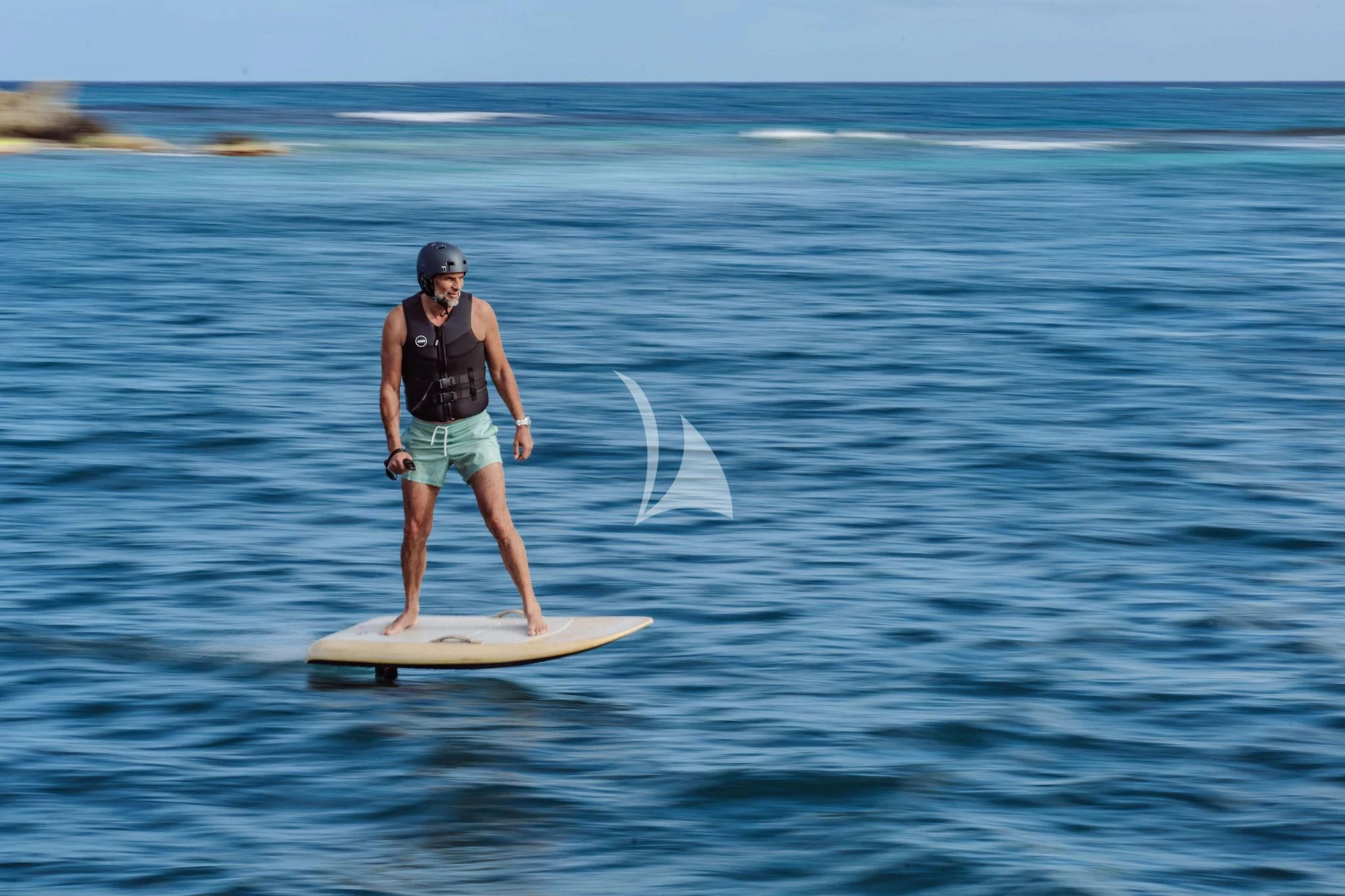 a man on a surfboard in the ocean aboard OCEANUS Yacht for Sale