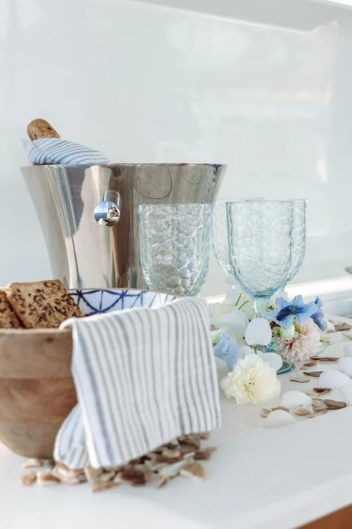 a table with a glass and a plate of food aboard OCEANUS Yacht for Sale