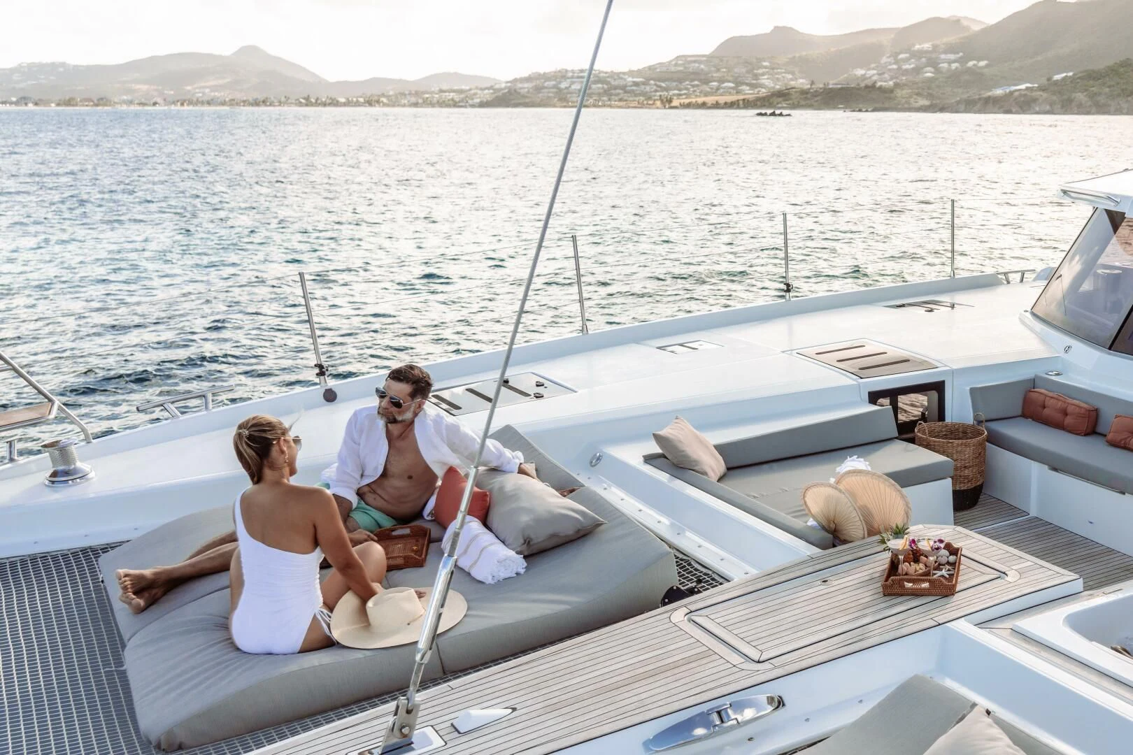 a man and woman sitting on a boat aboard OCEANUS Yacht for Sale
