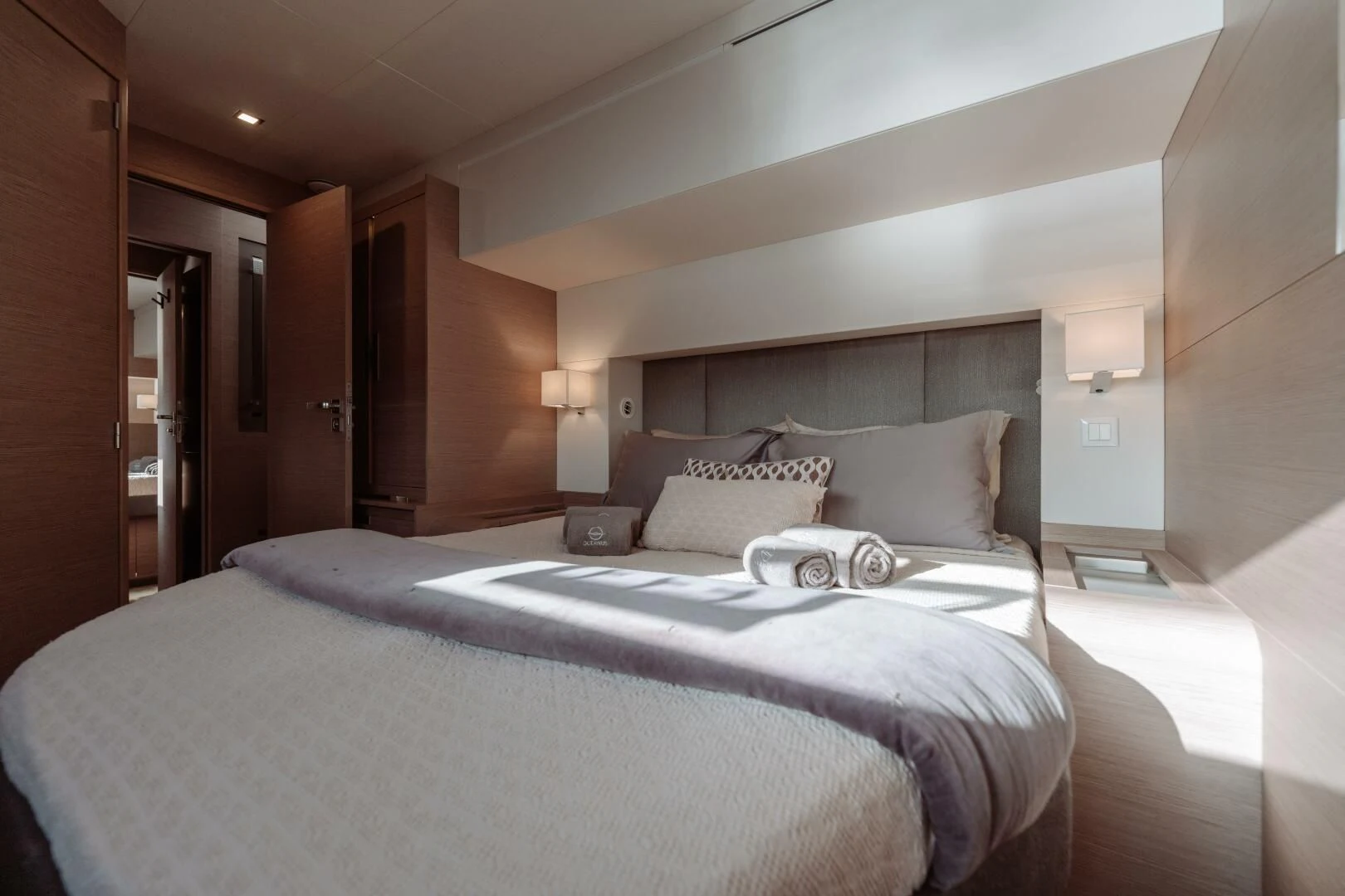 a bed with a white comforter aboard OCEANUS Yacht for Sale