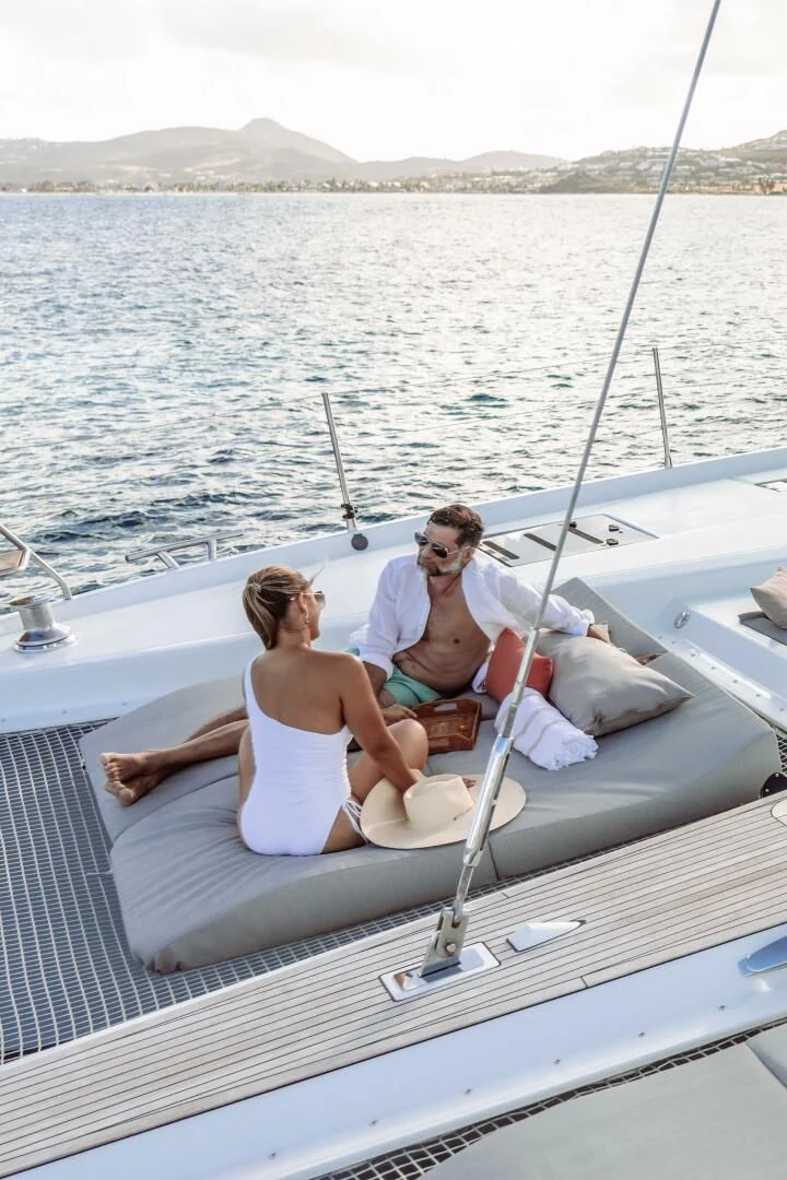a man and woman sitting on a boat aboard OCEANUS Yacht for Sale