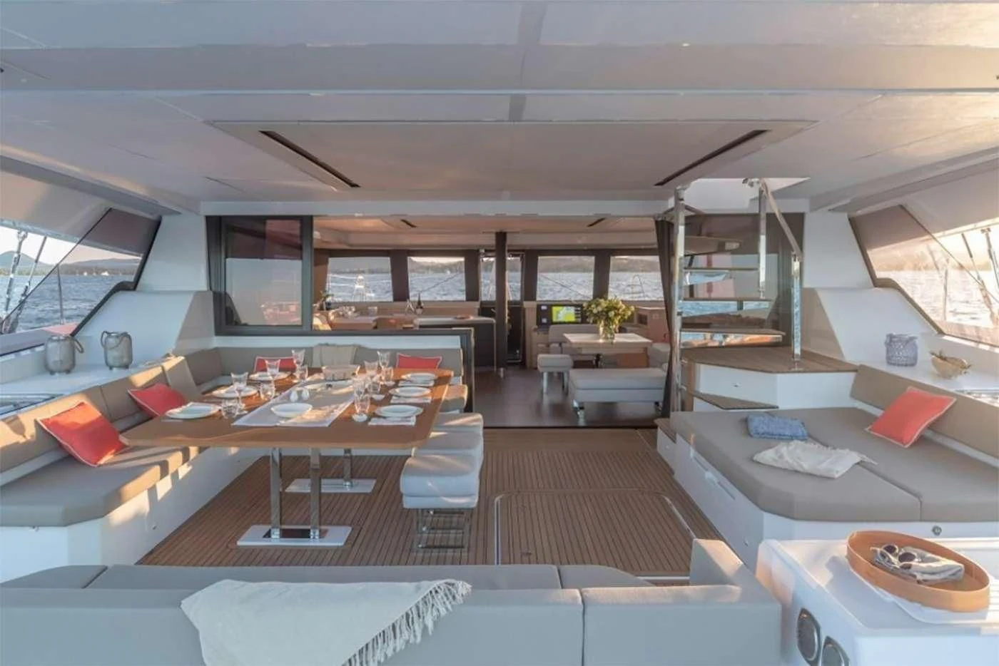 a room with a large window and a table with chairs and a shelf aboard OCEANUS Yacht for Sale