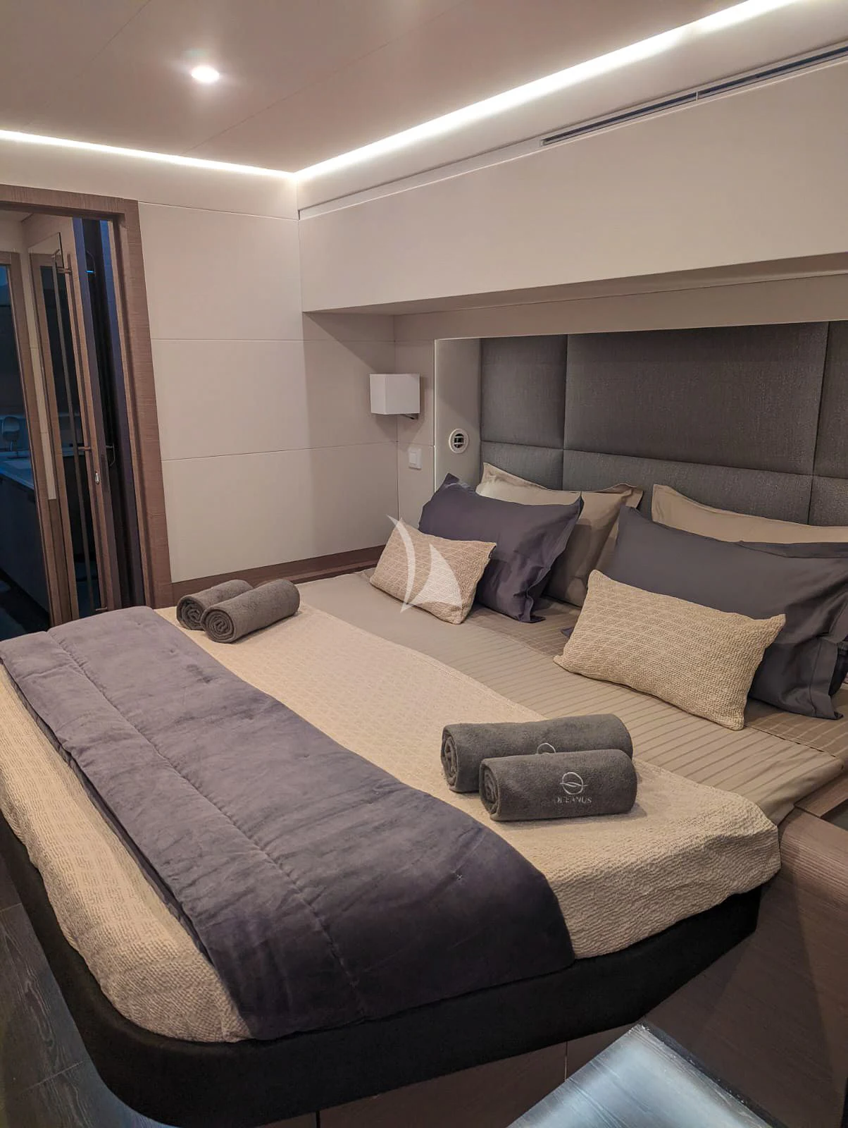 a bed with a black tray on it aboard OCEANUS Yacht for Sale