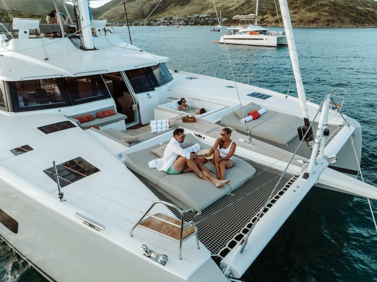 a couple of men sitting on a boat in the water aboard OCEANUS Yacht for Sale