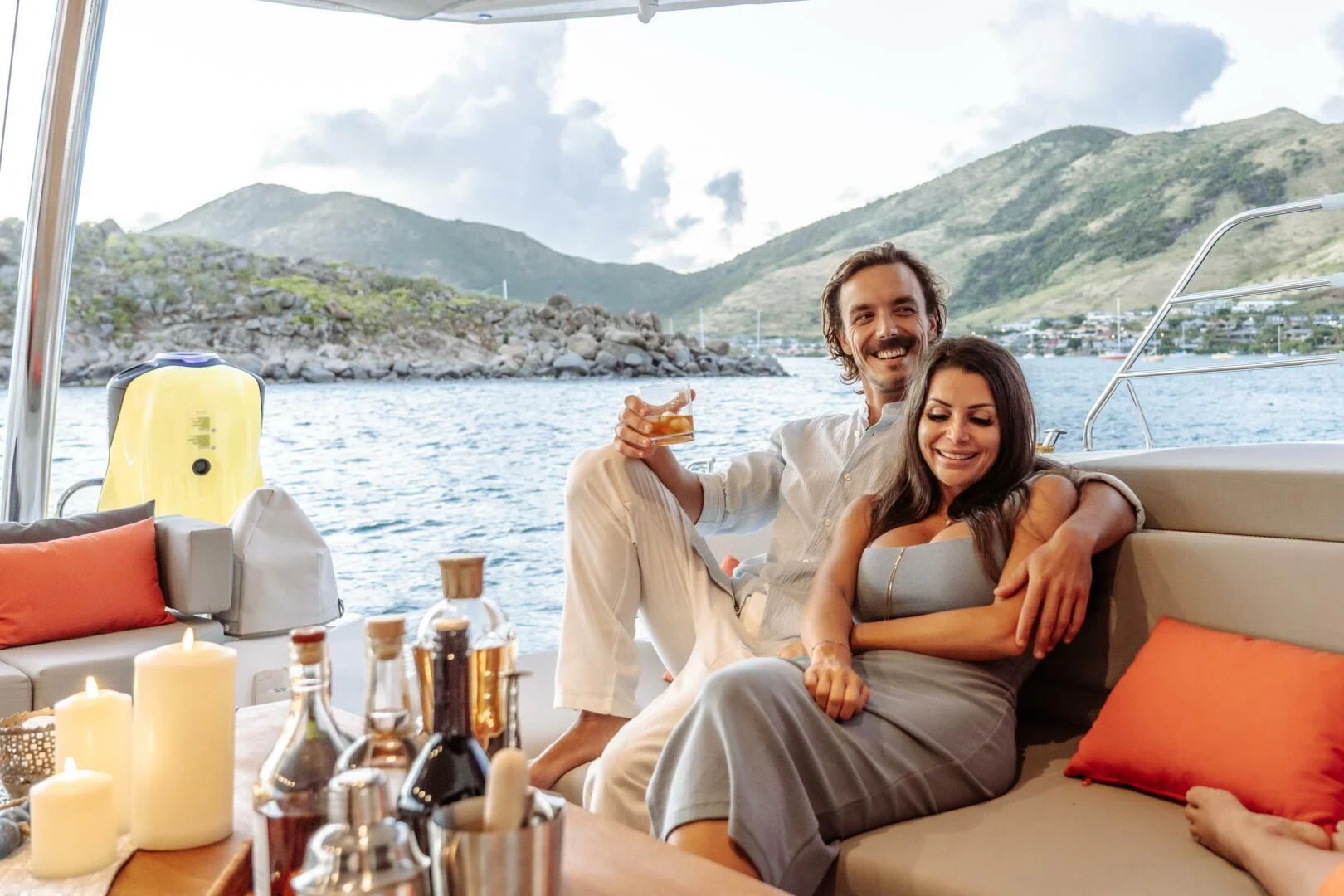 a man and woman sitting on a boat with a woman holding a hot dog aboard OCEANUS Yacht for Sale