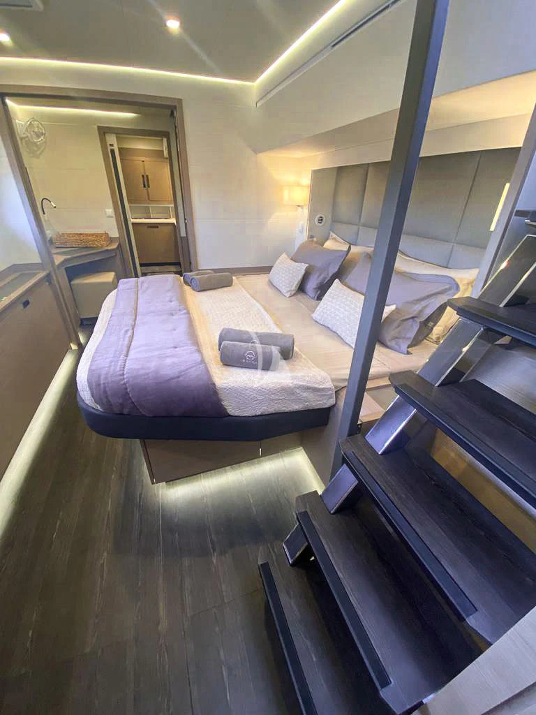 a room with a bed and a table aboard OCEANUS Yacht for Sale