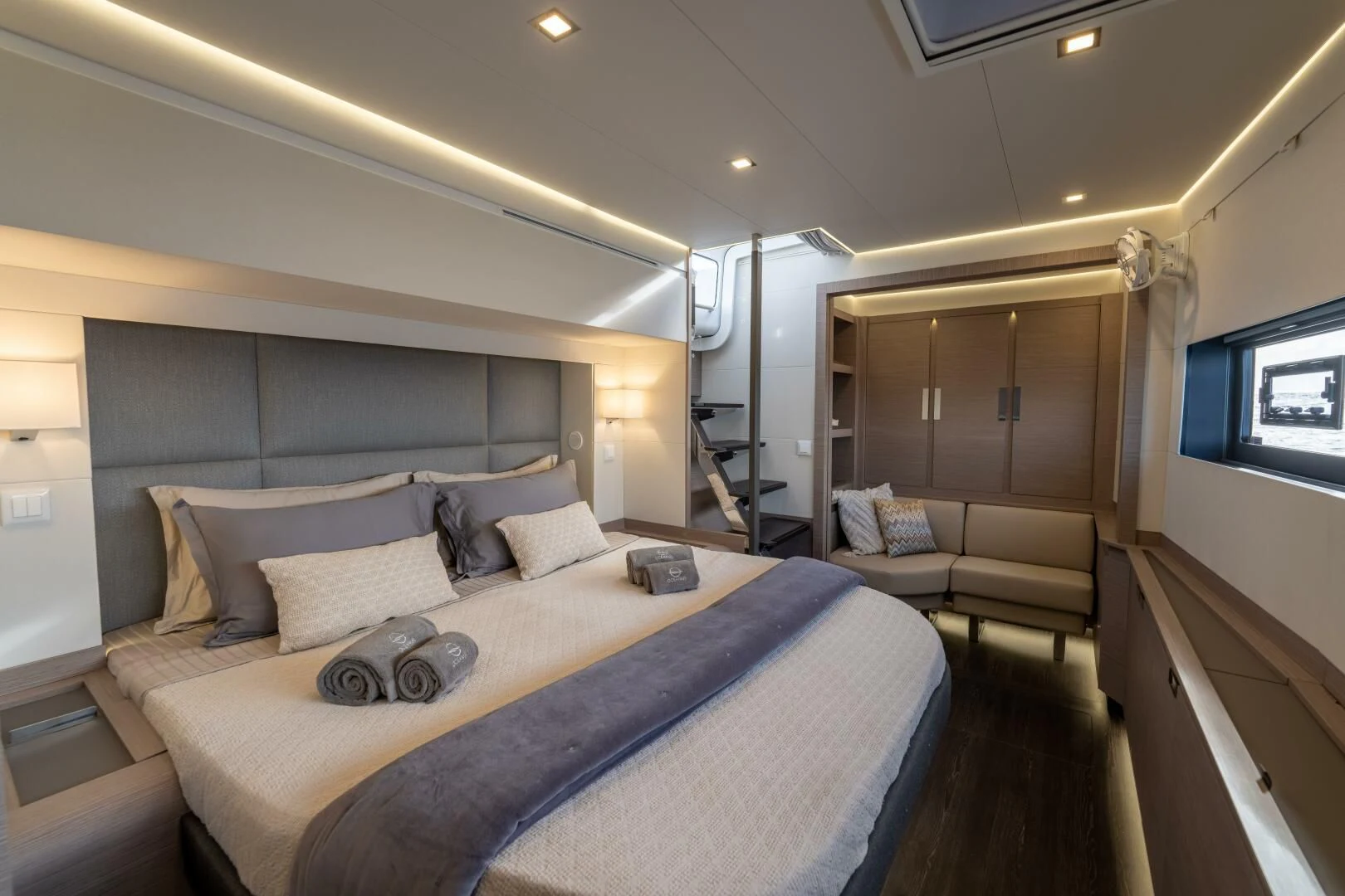 a bedroom with a bed and a couch aboard OCEANUS Yacht for Sale