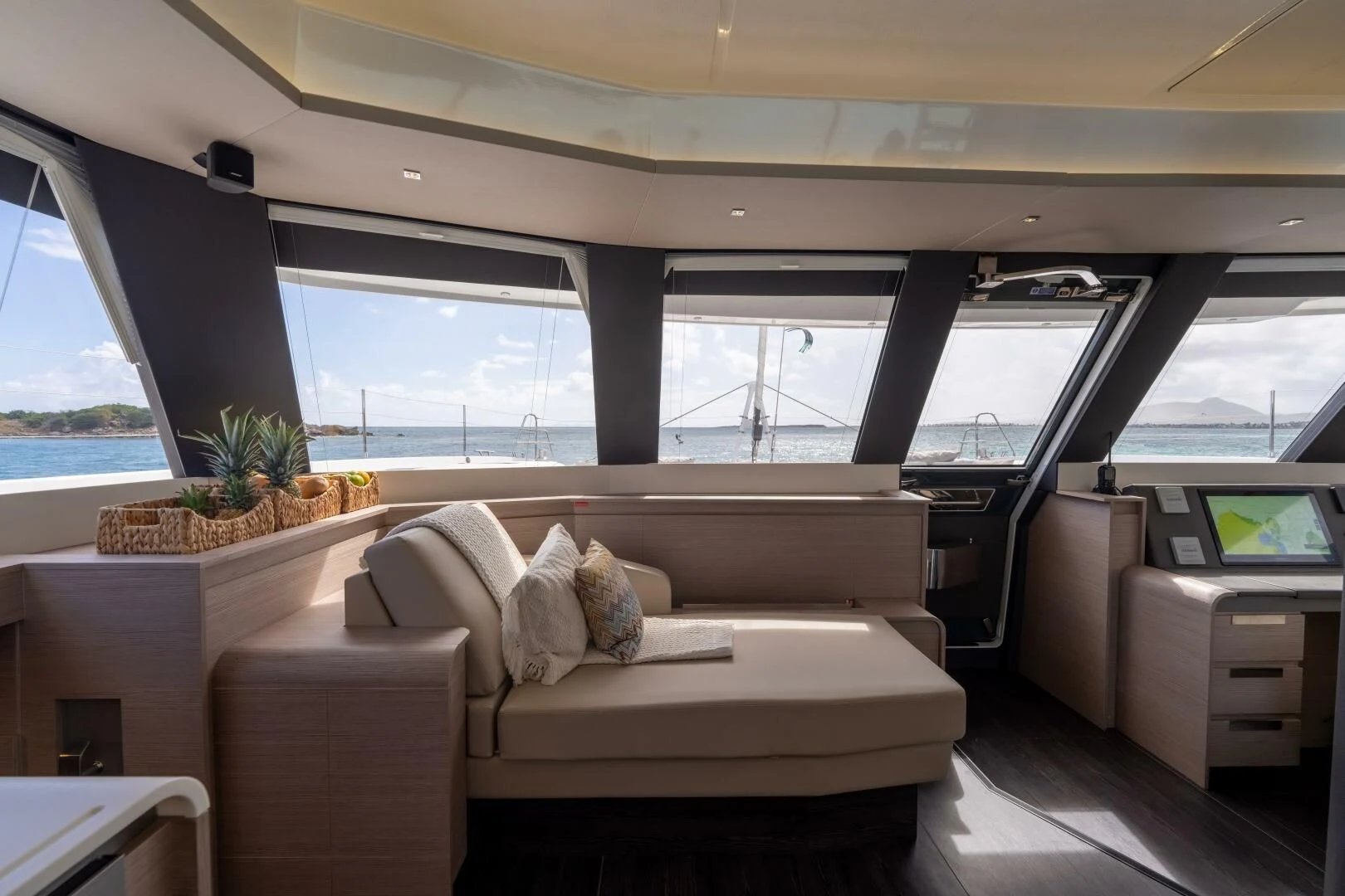 a room with a couch and a table and a window aboard OCEANUS Yacht for Sale