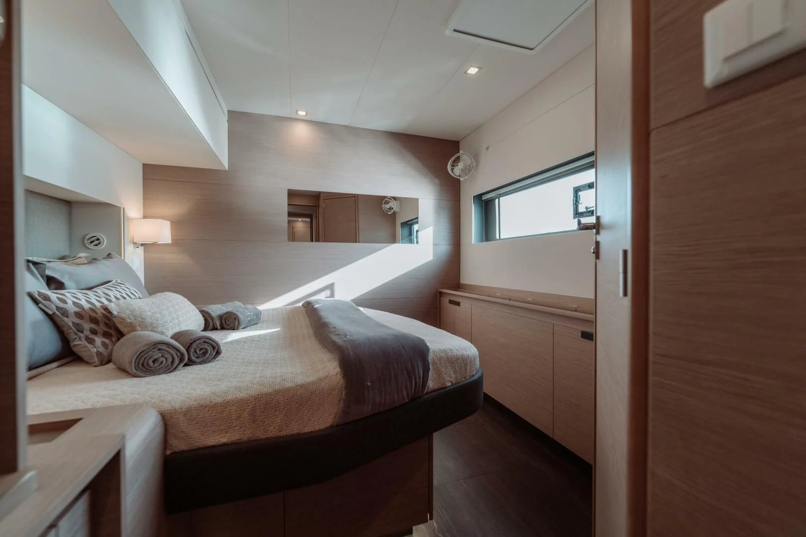 a bedroom with a bed and a mirror aboard OCEANUS Yacht for Sale