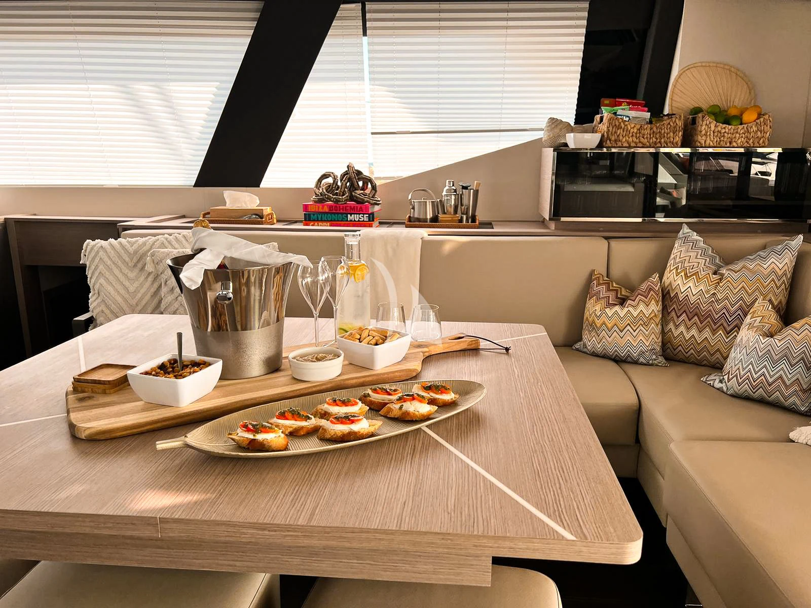 a kitchen with a table set with food and drinks aboard OCEANUS Yacht for Sale