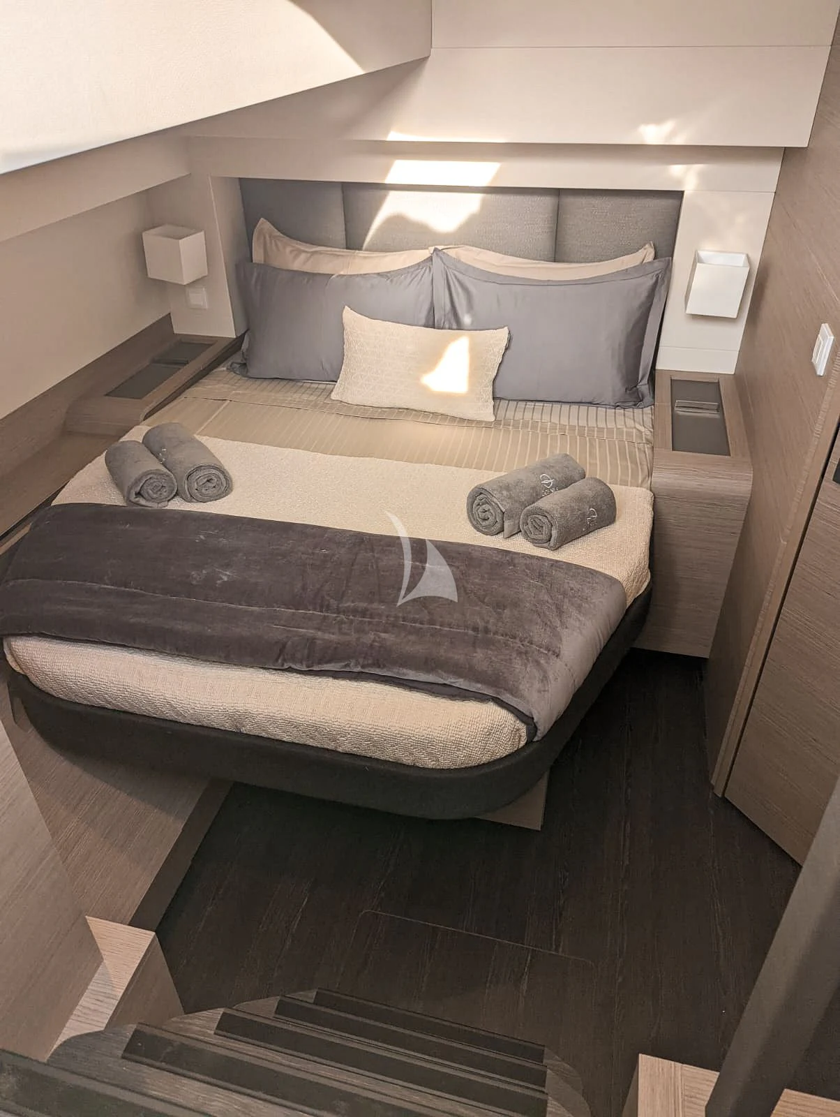a bed with pillows on it aboard OCEANUS Yacht for Sale