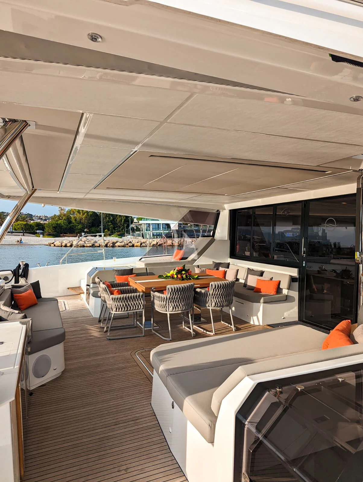 a room with a table chairs and a large pool aboard OCEANUS Yacht for Sale