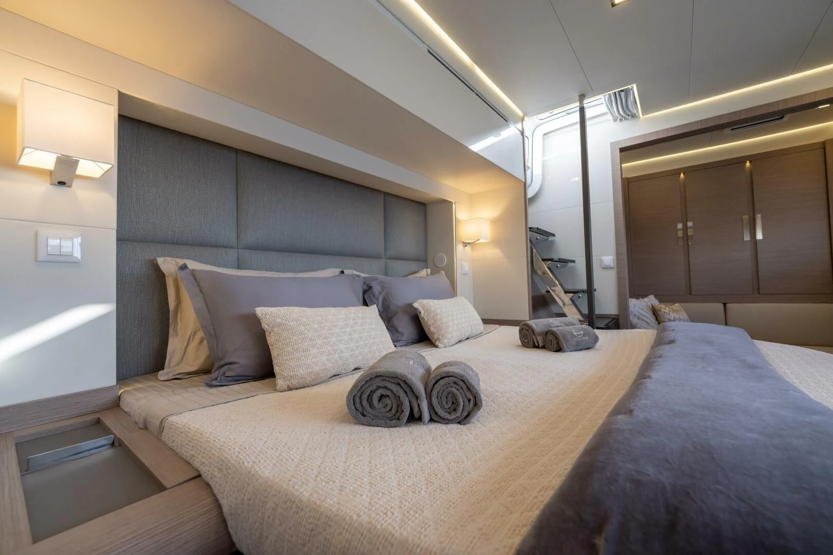 a bed with a blue blanket aboard OCEANUS Yacht for Sale