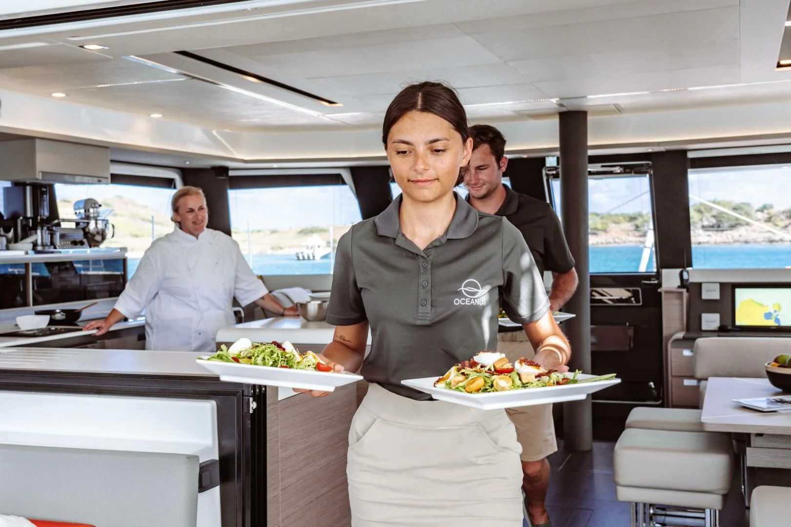 a person holding a tray of food aboard OCEANUS Yacht for Sale