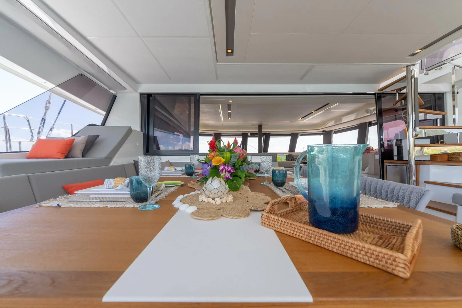 a table with a vase and glasses aboard OCEANUS Yacht for Sale