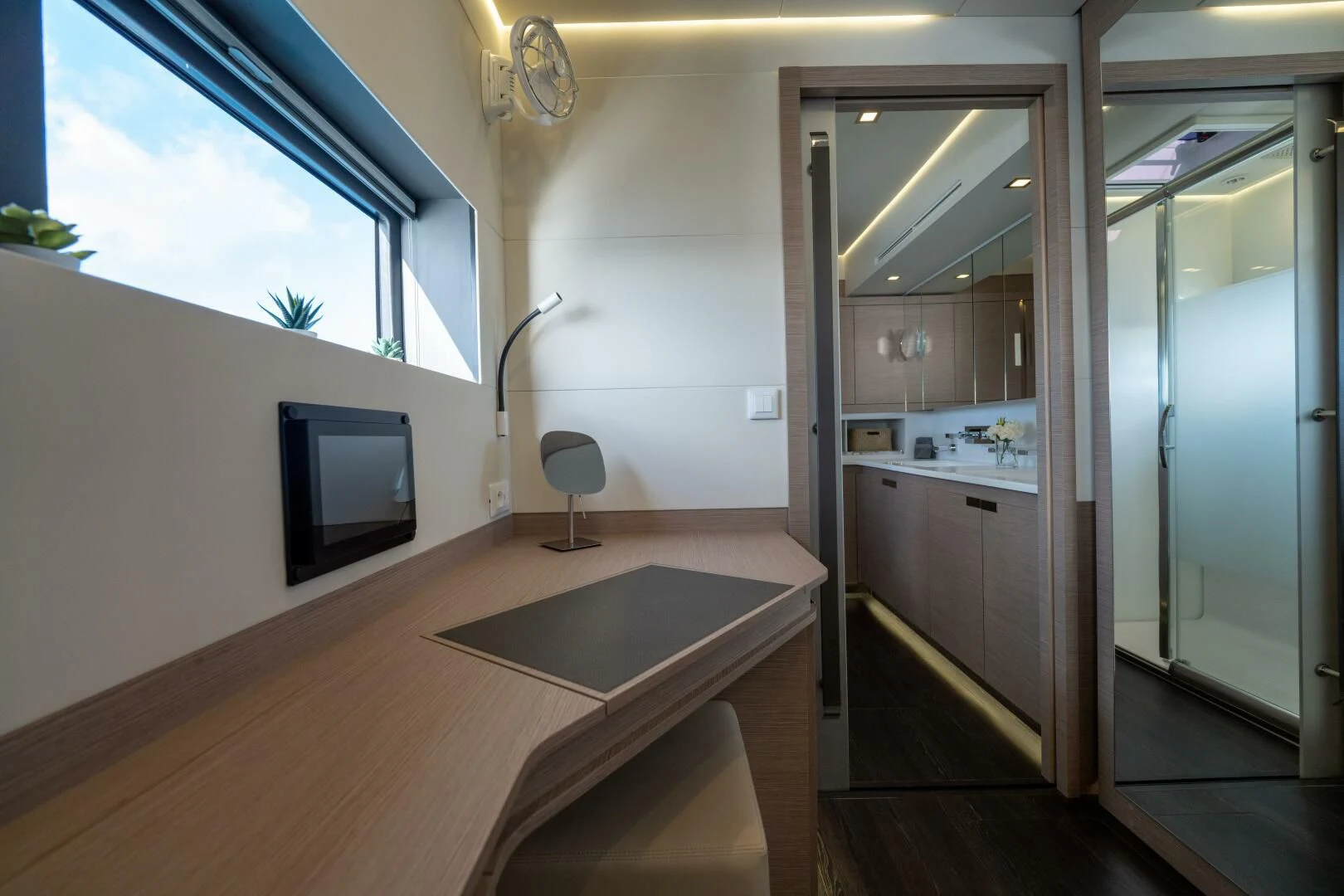 a room with a table and tv aboard OCEANUS Yacht for Sale