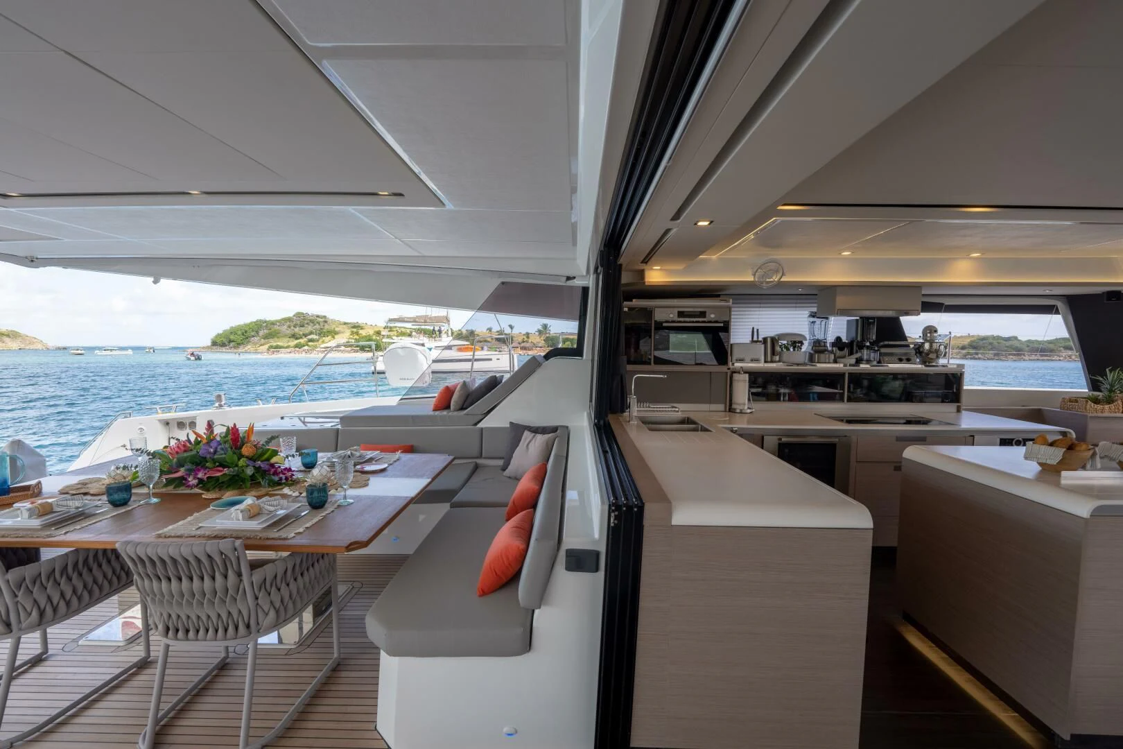 a room with a table chairs and a view of the ocean aboard OCEANUS Yacht for Sale