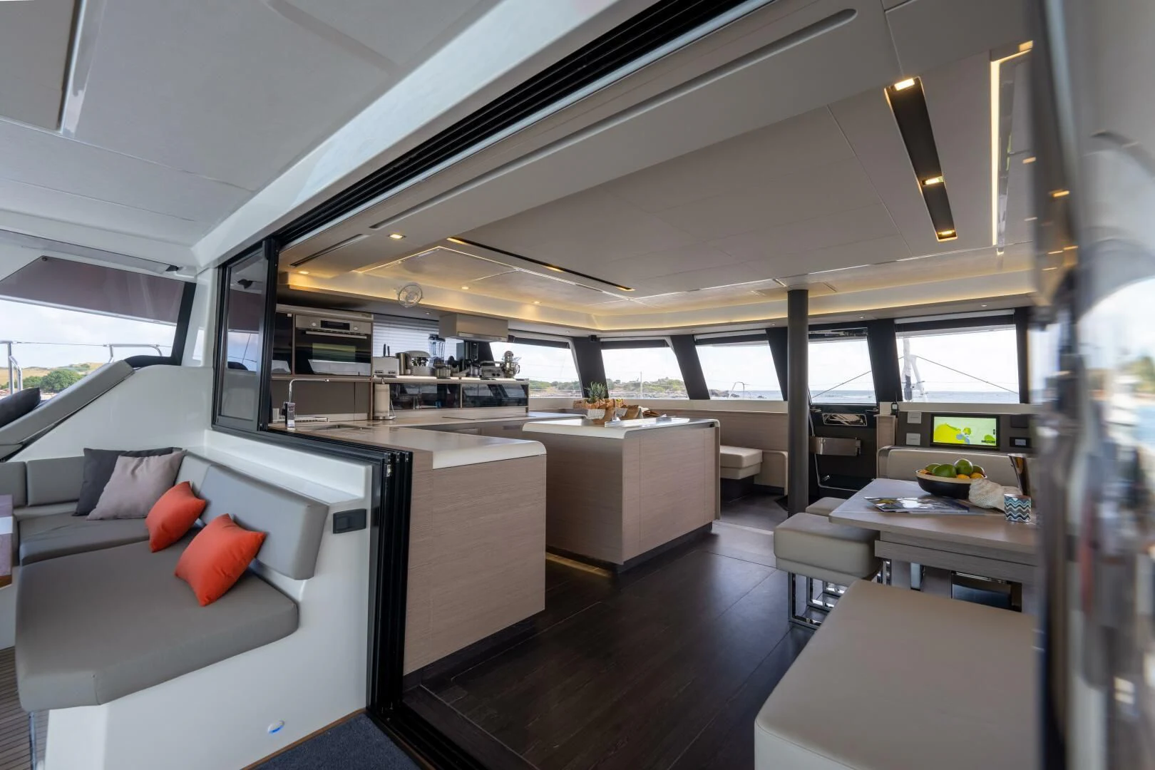 a room with a couch and a table and a large window aboard OCEANUS Yacht for Sale