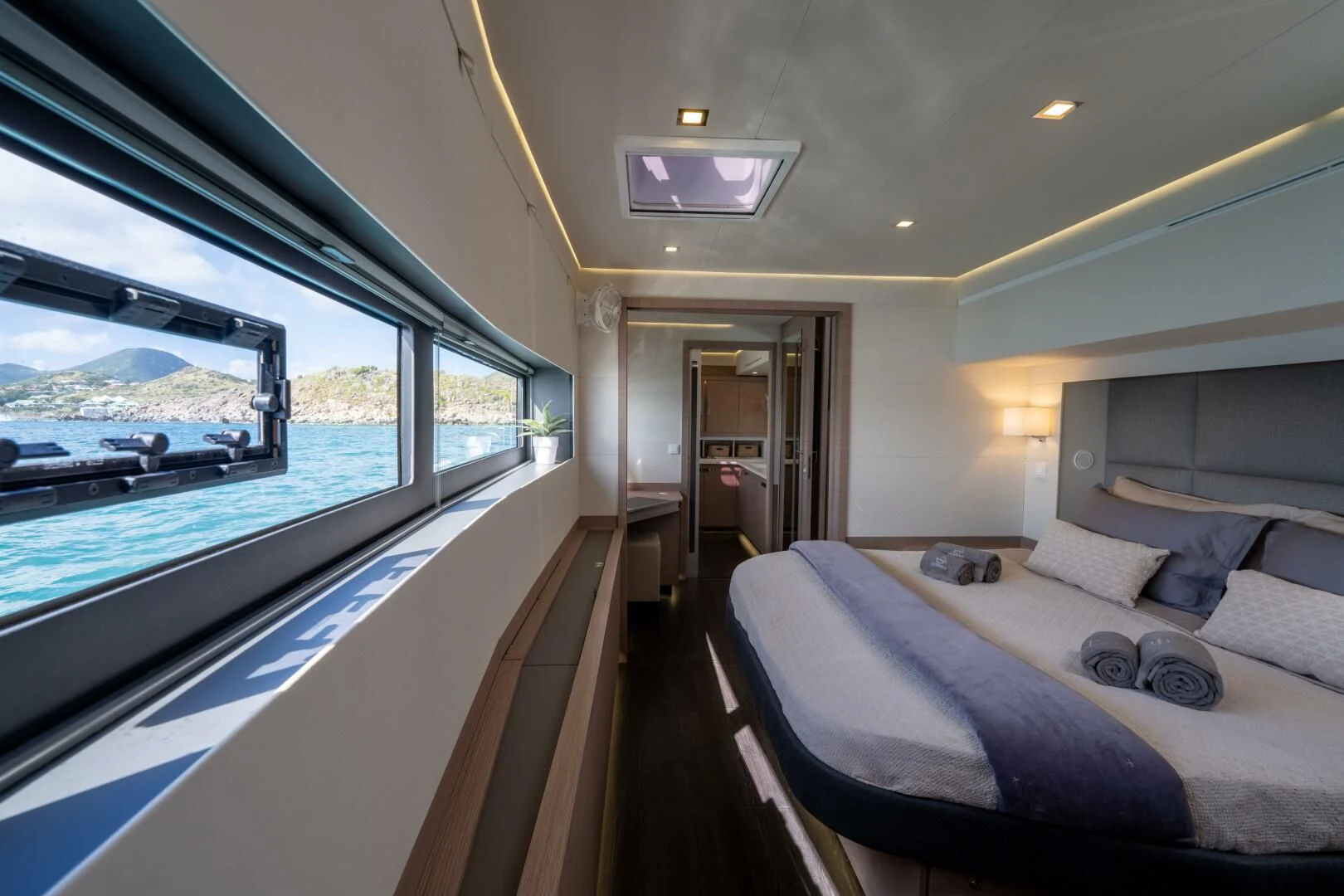 a boat with a bed and a large window aboard OCEANUS Yacht for Sale