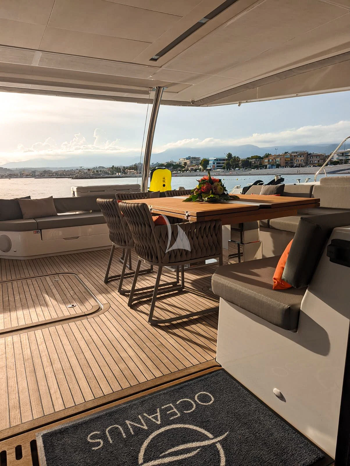 a living room with a table and chairs aboard OCEANUS Yacht for Sale