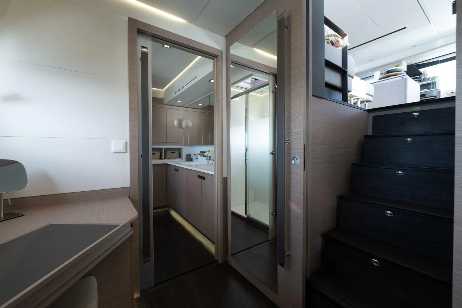 a room with a door and a mirror aboard OCEANUS Yacht for Sale
