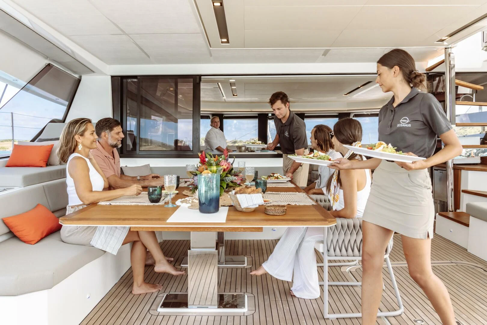 a group of people eating at a restaurant aboard OCEANUS Yacht for Sale