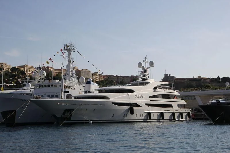 a large white boat sits at a dock aboard ST DAVID Yacht for Sale