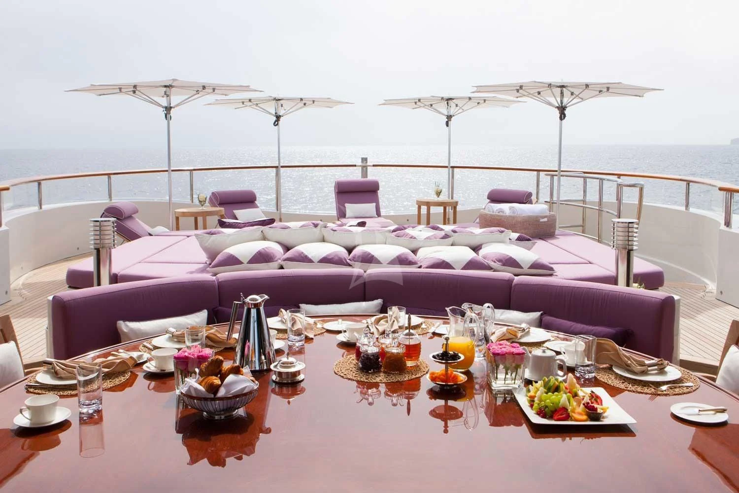 a purple and purple table set with purple and white chairs and a large body of water aboard ST DAVID Yacht for Sale