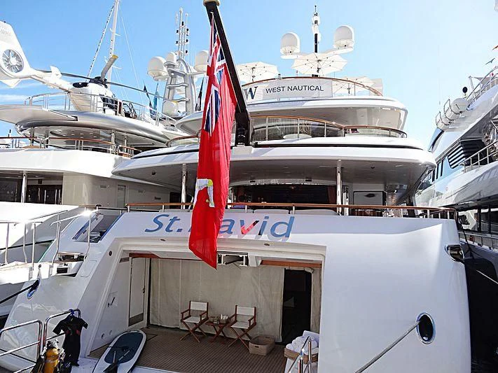 a large white boat with a red and blue flag on it aboard ST DAVID Yacht for Sale