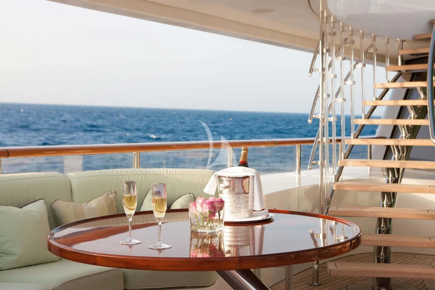 a table with wine glasses and a bottle on it aboard ST DAVID Yacht for Sale