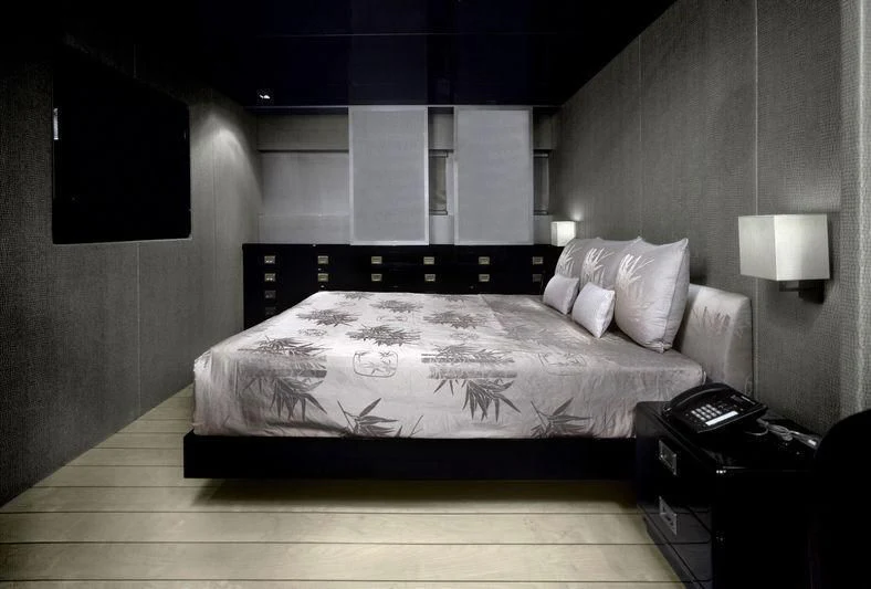 a bed with a white sheet aboard MAIN Yacht for Sale