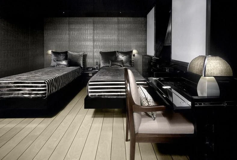 a bedroom with a bed and a desk aboard MAIN Yacht for Sale