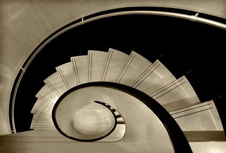 a circular staircase with a spiral staircase aboard MAIN Yacht for Sale
