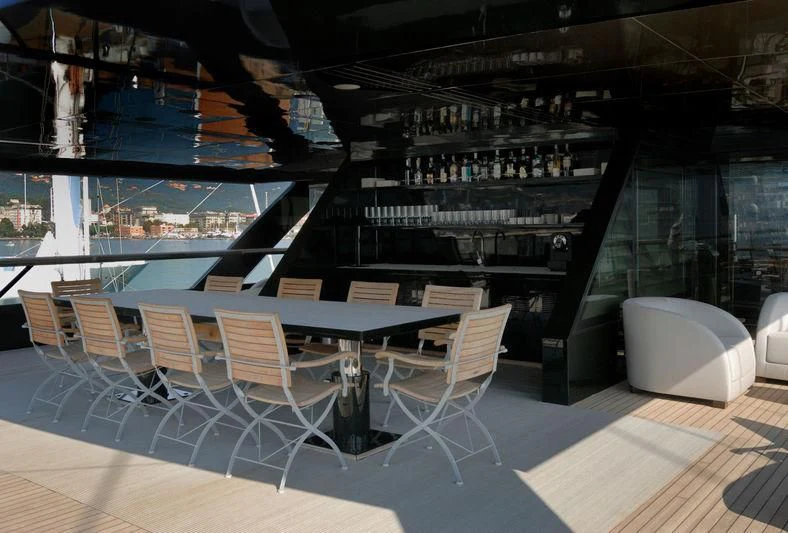 a room with a table and chairs aboard MAIN Yacht for Sale