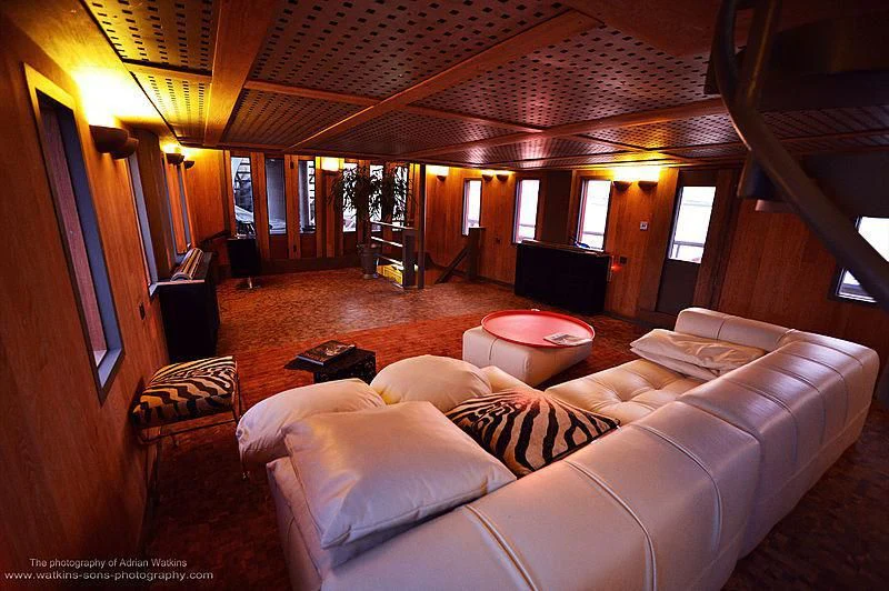 a living room with a large chandelier aboard MOJO Yacht for Sale
