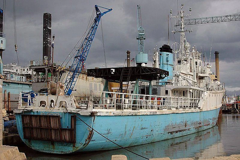 a large boat in a harbor aboard MOJO Yacht for Sale