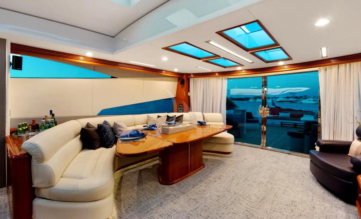 a living room with a couch and a table aboard PRIVEE Yacht for Sale
