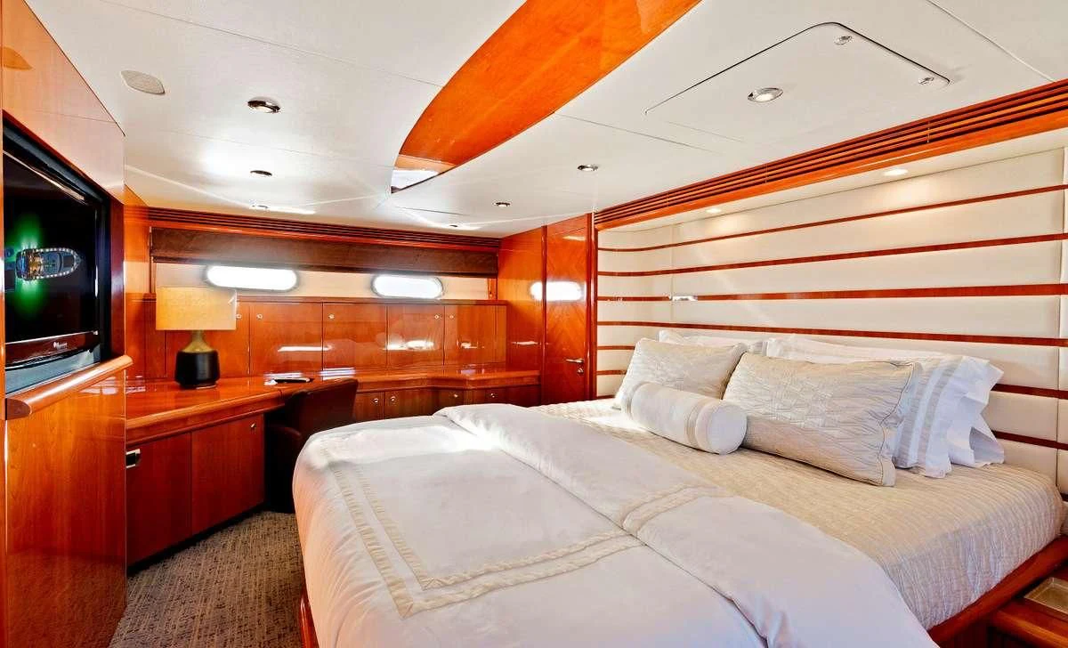 a bed with a white sheet aboard PRIVEE Yacht for Sale