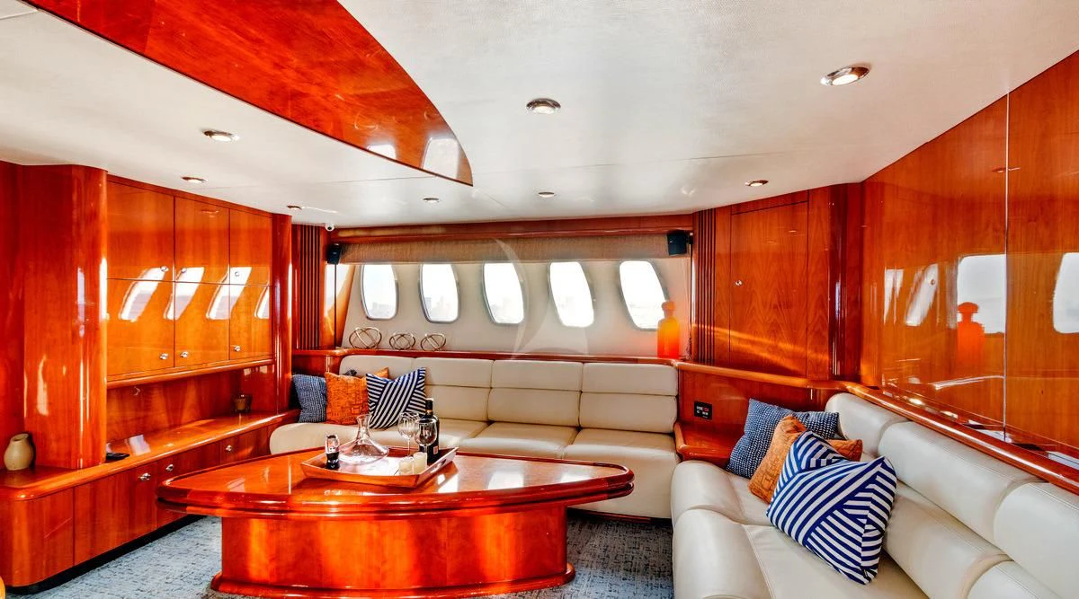 a living room with a couch and a table aboard PRIVEE Yacht for Sale