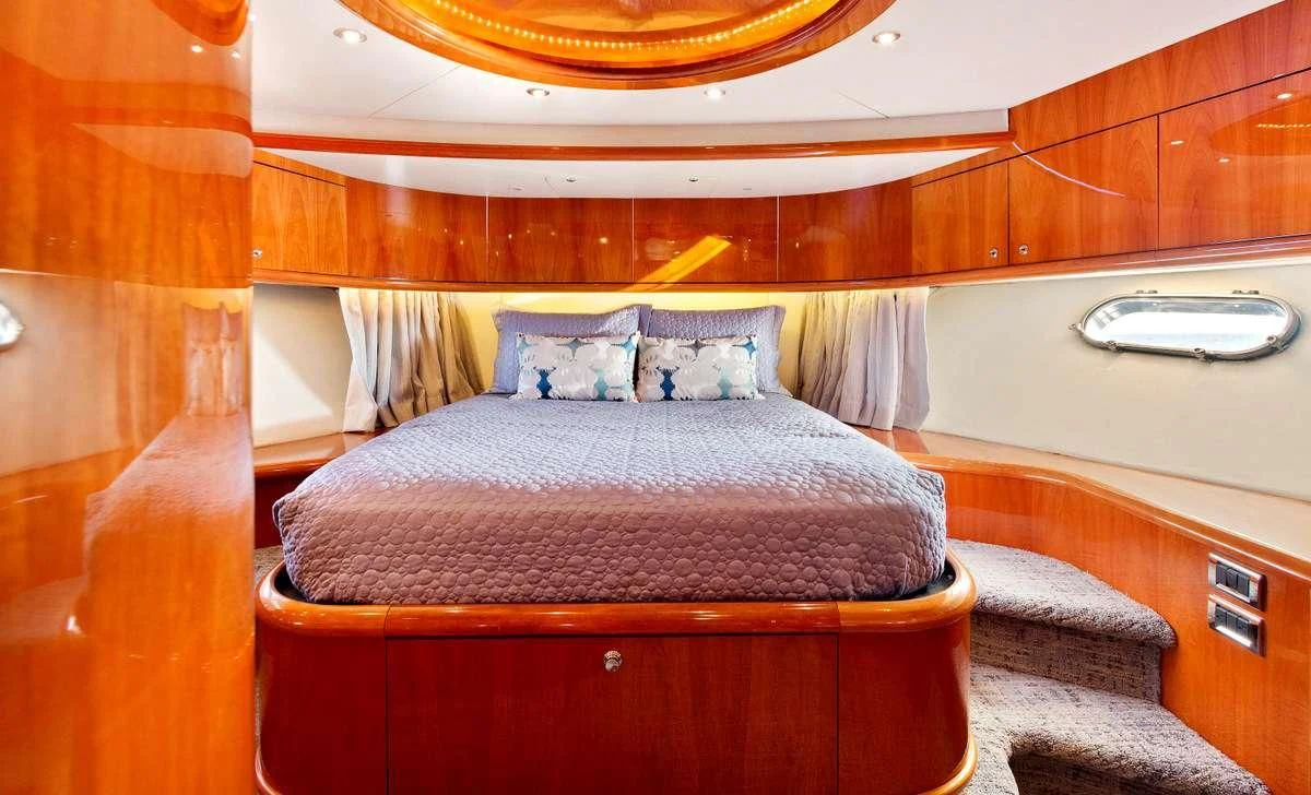 a bed with a purple blanket aboard PRIVEE Yacht for Sale