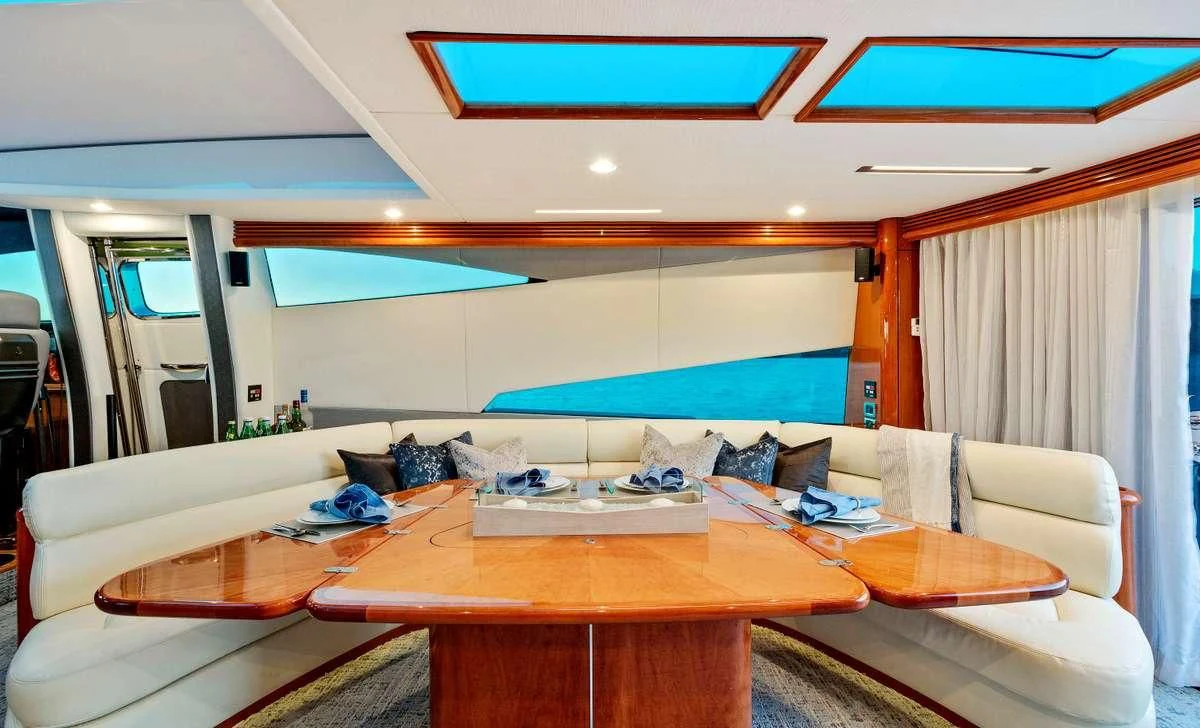 a room with a pool table and couches aboard PRIVEE Yacht for Sale